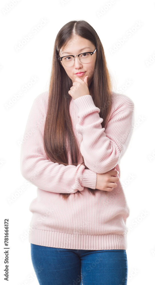 Young Chinese woman over isolated background wearing glasses looking confident at the camera with smile with crossed arms and hand raised on chin. Thinking positive. Young Chinese woman over isolated background wearing glasses looking confident at the camera with smile with crossed arms and hand raised on chin. Thinking positive.