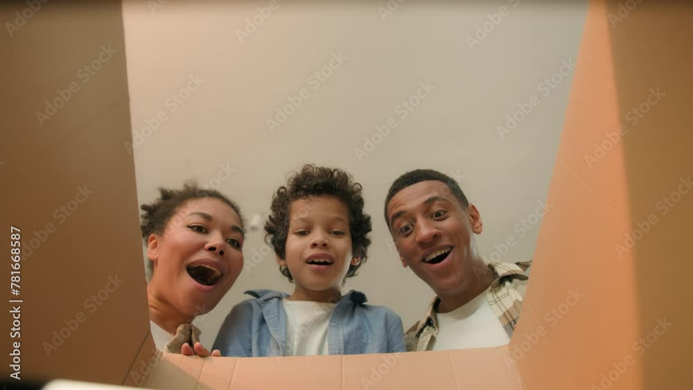 Point of view POV opening inside cardboard box happy surprised joyful African american family parents son little boy child kid order delivery unboxing unpacking parcel online shopping store moving day