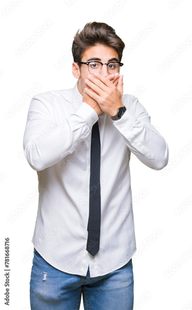 Young business man wearing glasses over isolated background shocked covering mouth with hands for mistake. Secret concept.