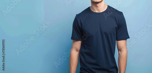 A stylish individual flaunting a trendy navy blue half-sleeve t-shirt, standing against a flat light blue background, epitomizing casual-chic fashion with effortless charm