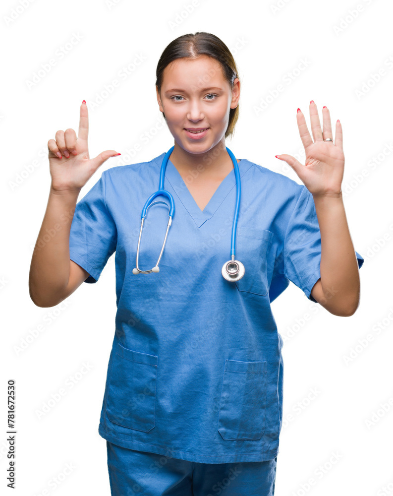 Young caucasian doctor woman wearing medical uniform over isolated background showing and pointing up with fingers number seven while smiling confident and happy. Young caucasian doctor woman wearing medical uniform over isolated background showing and pointing up with fingers number seven while smiling confident and happy.