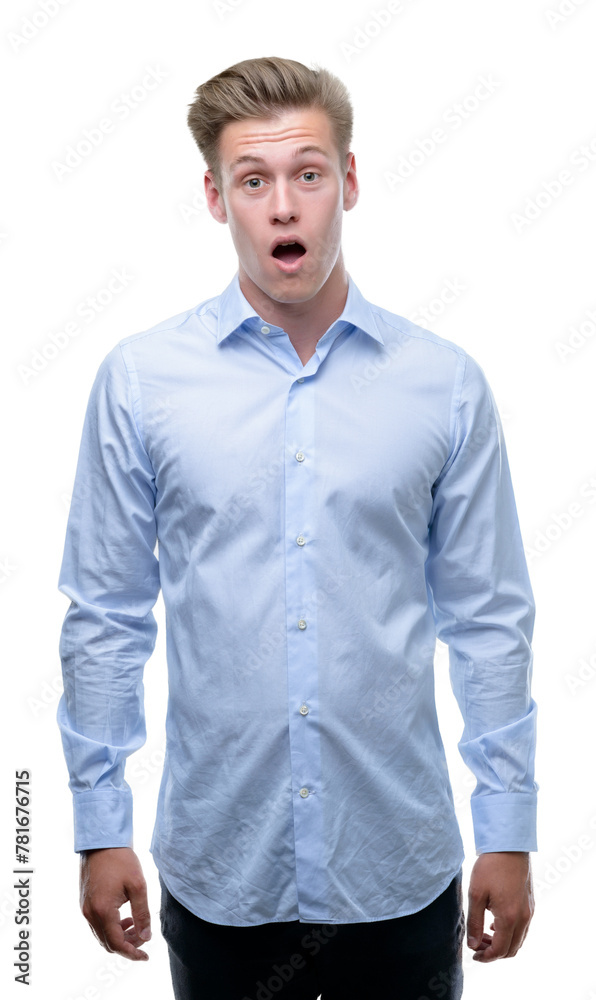 Young handsome blond man scared in shock with a surprise face, afraid and excited with fear expression Young handsome blond man scared in shock with a surprise face, afraid and excited with fear expression