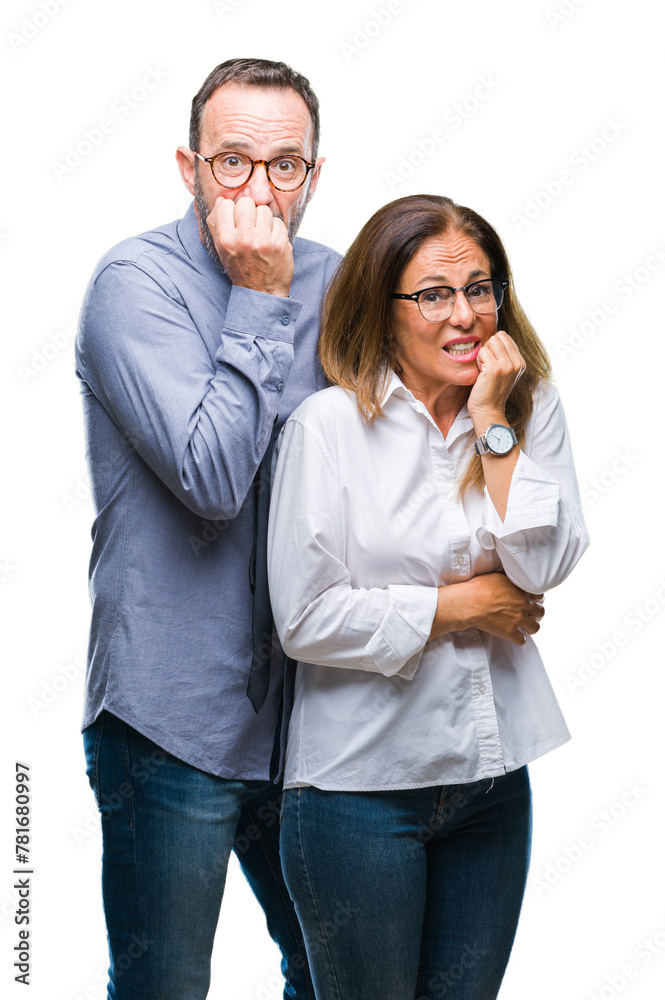 Middle age hispanic couple in love wearing glasses over isolated background looking stressed and nervous with hands on mouth biting nails. Anxiety problem. Middle age hispanic couple in love wearing glasses over isolated background looking stressed and nervous with hands on mouth biting nails. Anxiety problem.