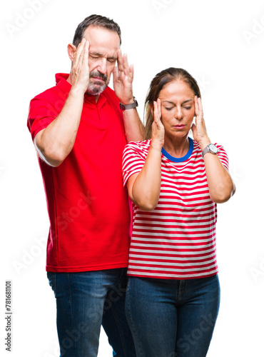 Middle age hispanic couple in love over isolated background with hand on head for pain in head because stress. Suffering migraine.