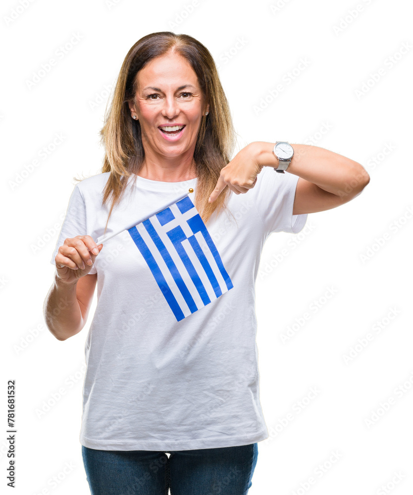 Middle age hispanic woman holding flag of Greece over isolated background with surprise face pointing finger to himself Middle age hispanic woman holding flag of Greece over isolated background with surprise face pointing finger to himself
