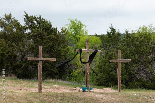 Three wooden Crosses at Easter Outdoors with Trees and Sky 