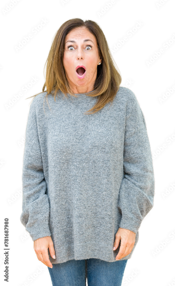 Beautiful middle age woman wearing winter sweater over isolated background In shock face, looking skeptical and sarcastic, surprised with open mouth Beautiful middle age woman wearing winter sweater over isolated background In shock face, looking skeptical and sarcastic, surprised with open mouth
