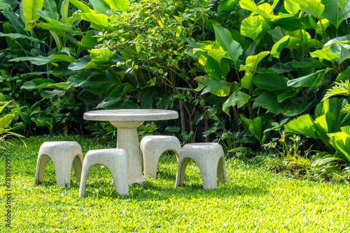 table and chairs on green grass in garden