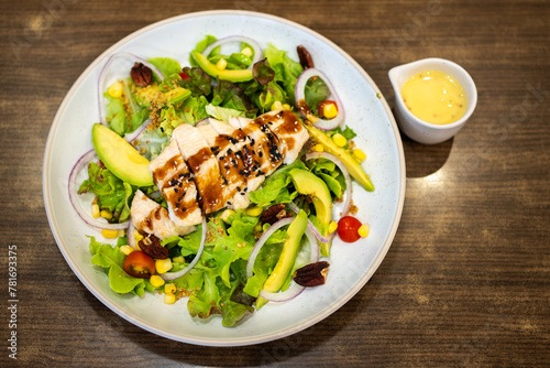 Grilled chicken breast, and fresh vegetable salad of lettuce, arugula, spinach, cucumber and tomato. Healthy lunch menu. © byjeng