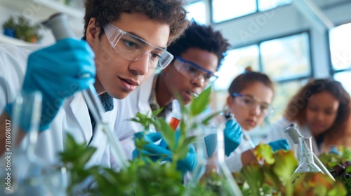 A group of students conducting experiments in a science lab learning about the process of producing biofuels from various organic materials. With the schools focus on sustainability .