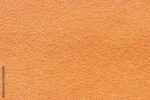 Close up orange fabric abstract background. Surface of felt fabric texture in autumn leaves color for copy space.