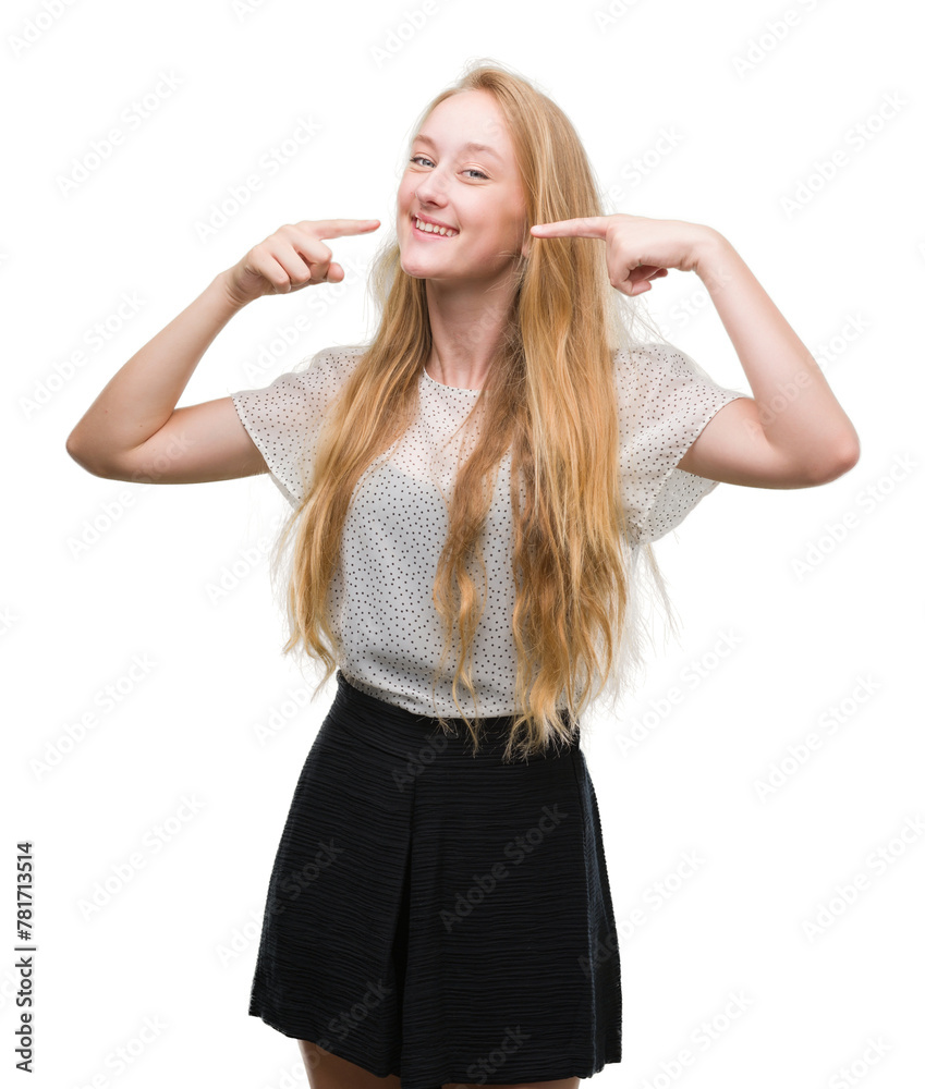 Blonde teenager woman wearing moles shirt smiling confident showing and pointing with fingers teeth and mouth. Health concept. Blonde teenager woman wearing moles shirt smiling confident showing and pointing with fingers teeth and mouth. Health concept.