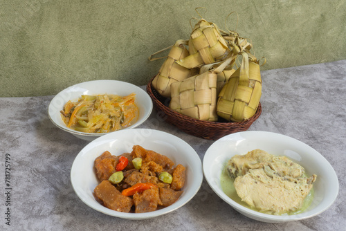 Ketupat Lebaran, served with opor ayam, sambal goreng krecek and sayur labu siam. Traditional celebratory dishes during Eid al-Fitr in Indonesia. photo
