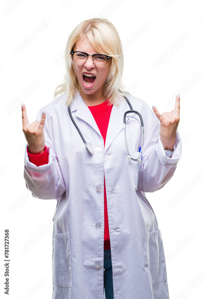 Young beautiful blonde doctor woman wearing medical uniform over isolated background shouting with crazy expression doing rock symbol with hands up. Music star. Heavy concept. Young beautiful blonde doctor woman wearing medical uniform over isolated background shouting with crazy expression doing rock symbol with hands up. Music star. Heavy concept.