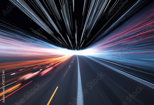 A dramatic abstract view of a highway at night, with streaking lights creating a radiant starburst effect