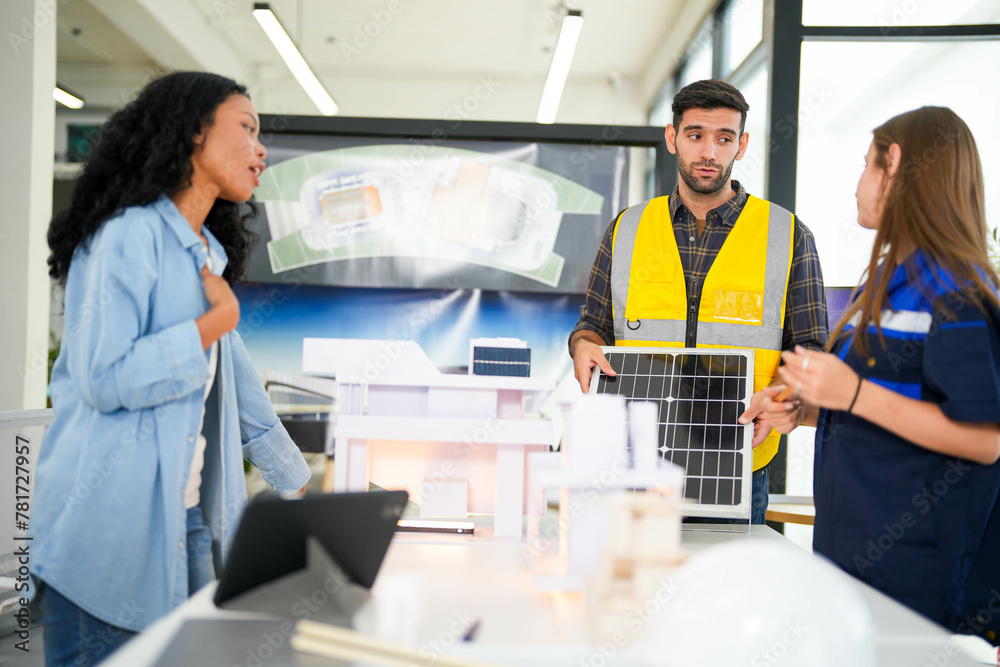 Obraz premium Architect and engineers wearing safety vests while analyzing solar power solutions over architectural plans.