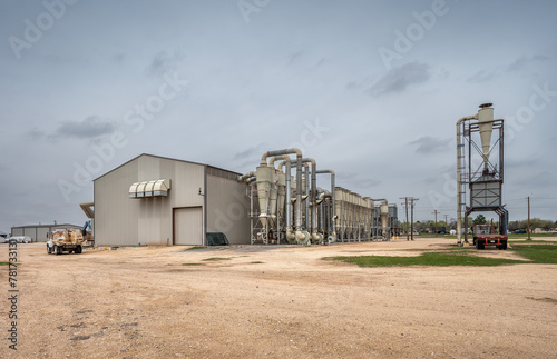 Metal building and equipment at a cotton gin in the town of Welch, Texas, United States