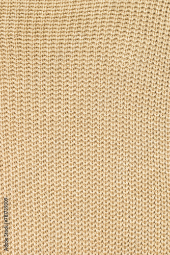 Background of light beige knitted fabric.