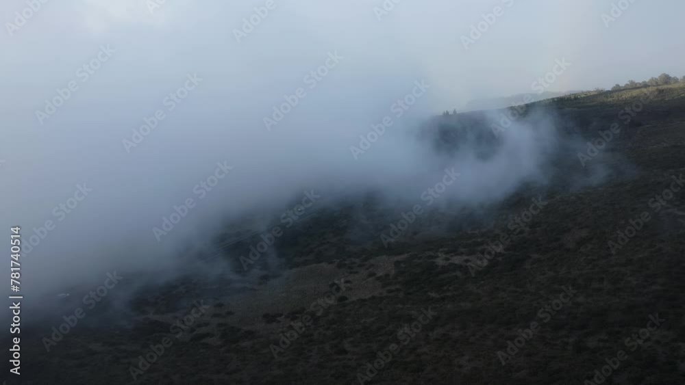 White clouds moving over the slopes of the Haleakala volcano in Maui. Drone view. White clouds moving over the slopes of the Haleakala volcano in Maui. Drone view.
