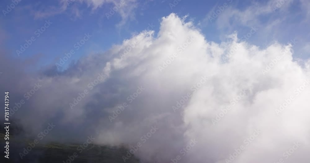 Drone view of high white clouds moving over the Haleakala volcano on Maui, Hawaii at daylight. Drone view of high white clouds moving over the Haleakala volcano on Maui, Hawaii at daylight.