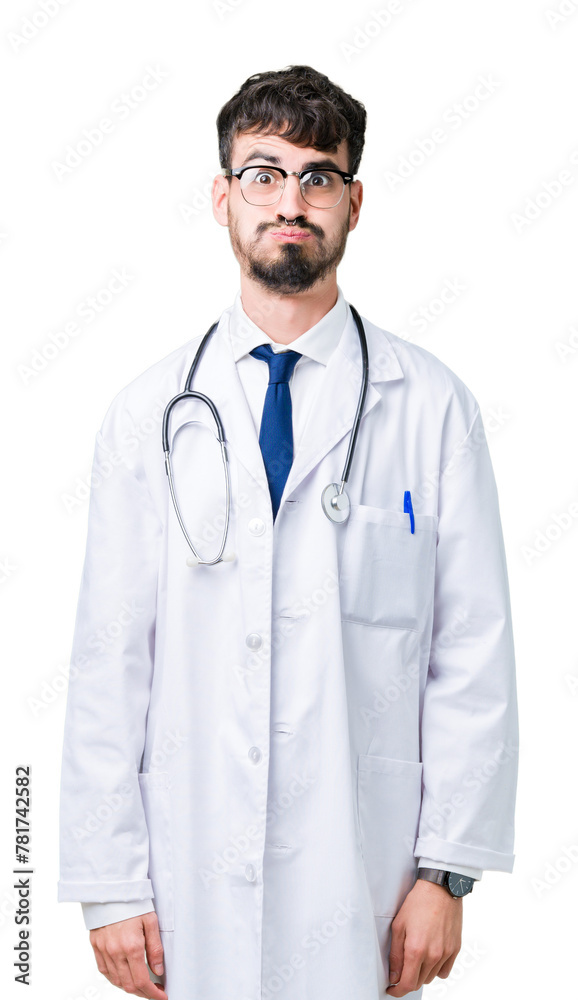 Young doctor man wearing hospital coat over isolated background puffing cheeks with funny face. Mouth inflated with air, crazy expression. Young doctor man wearing hospital coat over isolated background puffing cheeks with funny face. Mouth inflated with air, crazy expression.