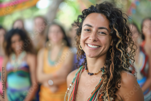 Smiling Hispanic woman with group during yoga retreat
