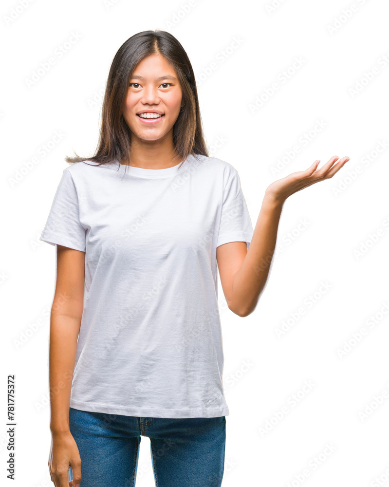 Young asian woman over isolated background smiling cheerful presenting and pointing with palm of hand looking at the camera. Young asian woman over isolated background smiling cheerful presenting and pointing with palm of hand looking at the camera.