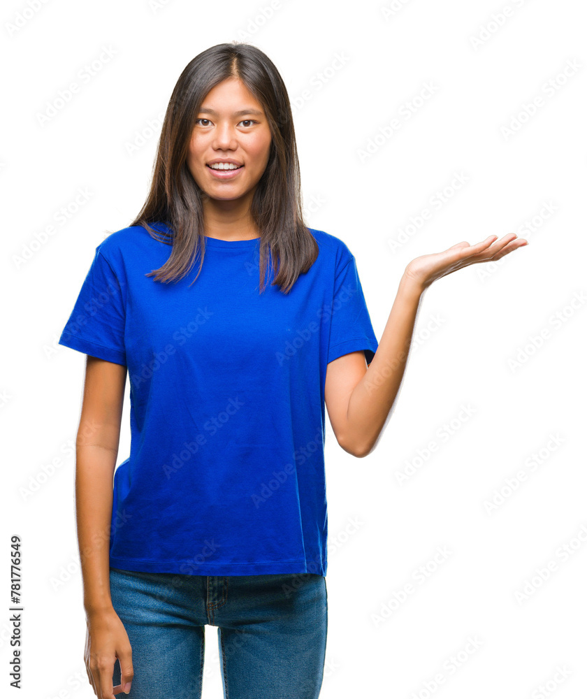 Young asian woman over isolated background smiling cheerful presenting and pointing with palm of hand looking at the camera. Young asian woman over isolated background smiling cheerful presenting and pointing with palm of hand looking at the camera.