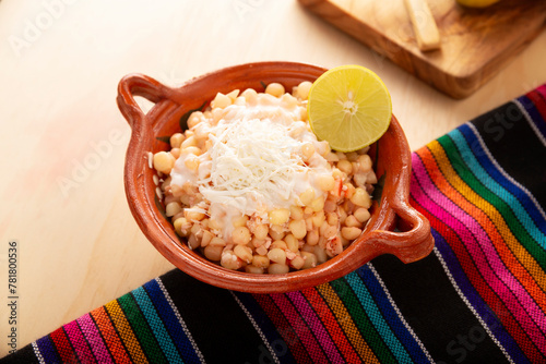Esquites. Corn kernels cooked and served with mayo, sour cream, lemon and chili powder, very popular street food in Mexico, also known as Elote en Vaso. The recipe varies depending on the region.