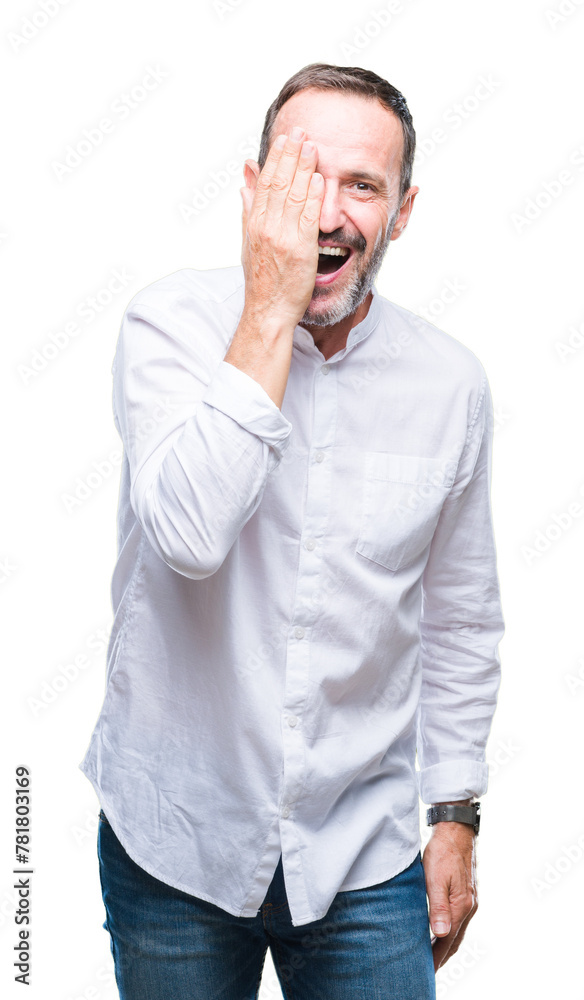 Middle age hoary senior man over isolated background covering one eye with hand with confident smile on face and surprise emotion. Middle age hoary senior man over isolated background covering one eye with hand with confident smile on face and surprise emotion.