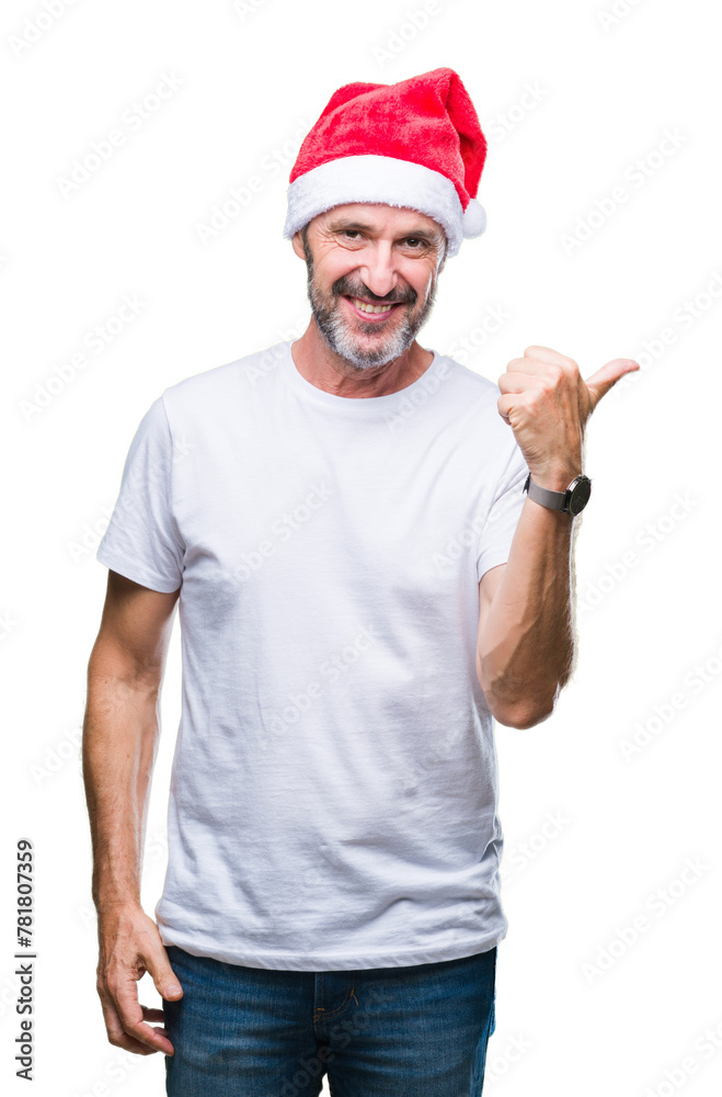 Middle age hoary senior man wearing christmas hat over isolated background smiling with happy face looking and pointing to the side with thumb up. Middle age hoary senior man wearing christmas hat over isolated background smiling with happy face looking and pointing to the side with thumb up.