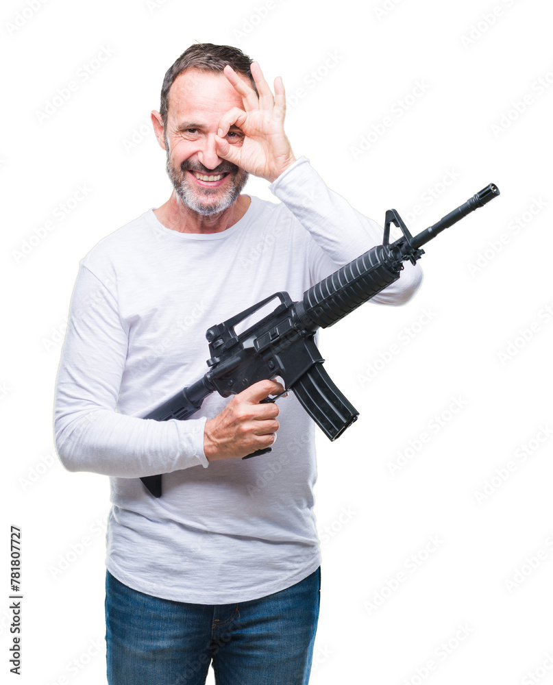 Middle age senior hoary criminal man holding gun weapon over isolated background with happy face smiling doing ok sign with hand on eye looking through fingers Middle age senior hoary criminal man holding gun weapon over isolated background with happy face smiling doing ok sign with hand on eye looking through fingers