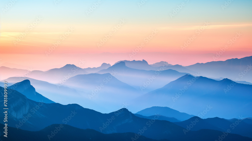 Tranquil scene of layered blue mountain silhouettes complemented by soft gradient colors from sunset to dusk showcasing the calmness of nature