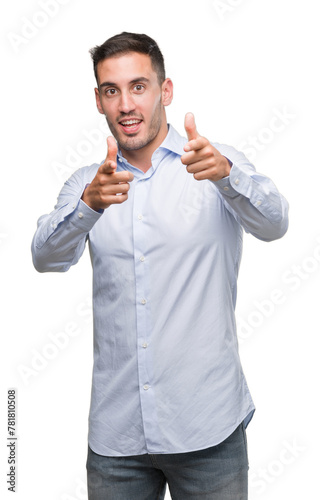 Handsome young businessman pointing fingers to camera with happy and funny face. Good energy and vibes. © Krakenimages.com