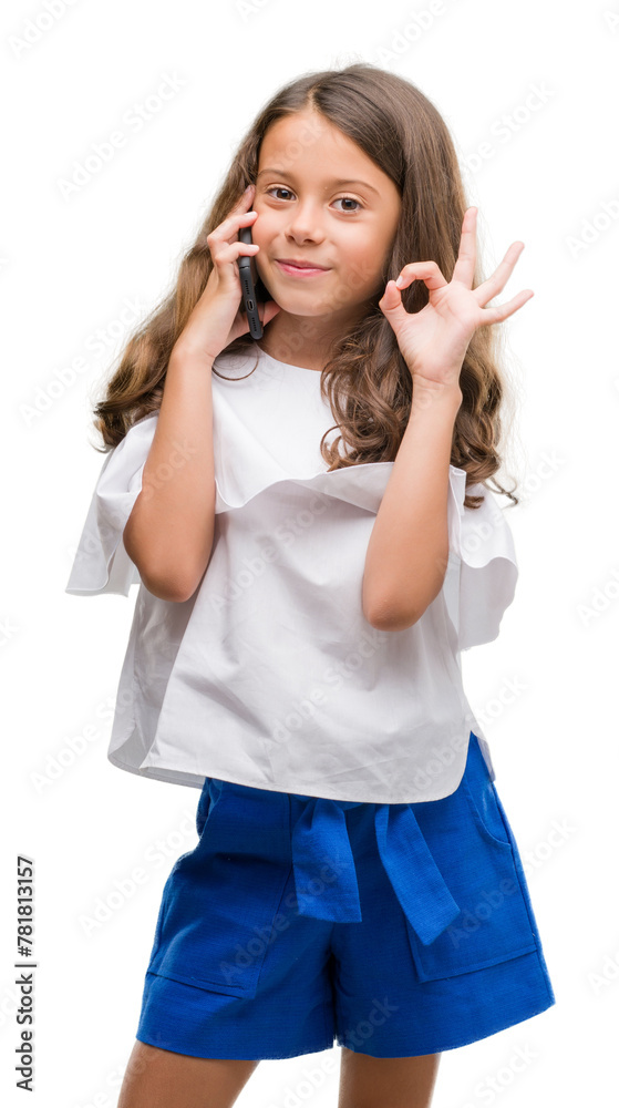 Brunette hispanic girl using smartphone doing ok sign with fingers, excellent symbol Brunette hispanic girl using smartphone doing ok sign with fingers, excellent symbol