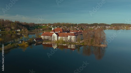 Kloster Seeon, catholic monastery in Bavaria, Germany. Church on lake island. Scenic alps mountains photo