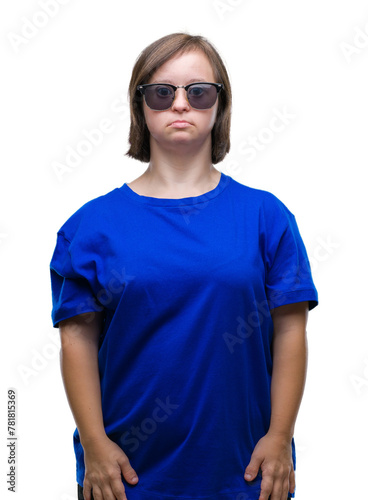 Young adult woman with down syndrome wearing sunglasses over isolated background with serious expression on face. Simple and natural looking at the camera.