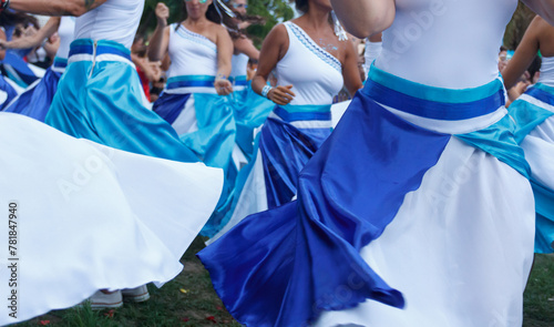 Women dancing maracatu with colorful red and blue dresses in Rio de Janeiro, Brazil during carnival.