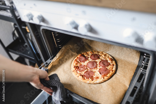 Girl cooking pizza at home