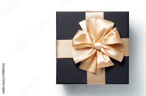 Black gift box with champagne gold ribbon bow on white background, top view
