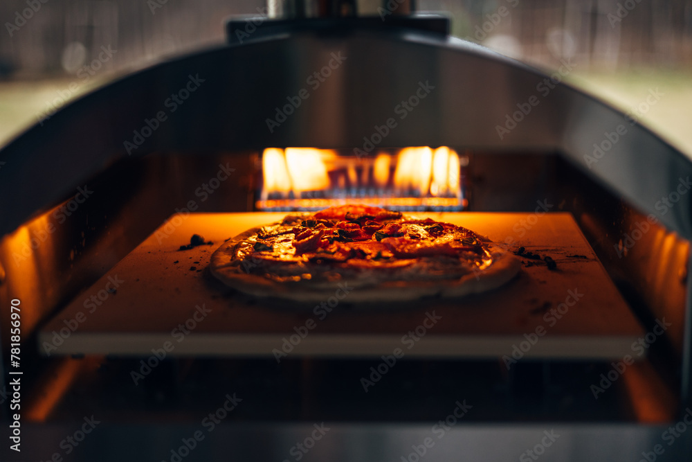 Pizza cooking in a pizza oven