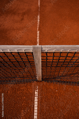Bokeh on tennis net on red clay court