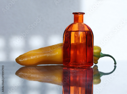 Glass bottle and  sweet long pepper