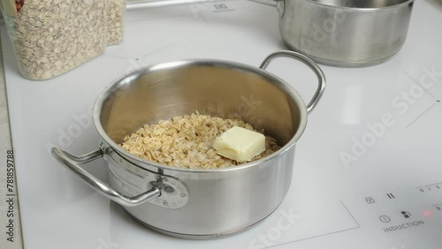 The video shows oatmeal cooking in a saucepan, demonstrating the process of preparing a healthy breakfast. Suitable for culinary clips and promoting a healthy lifestyle