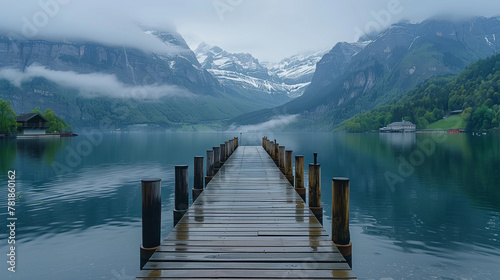 wooden pier leading into the lake, mountains in the background