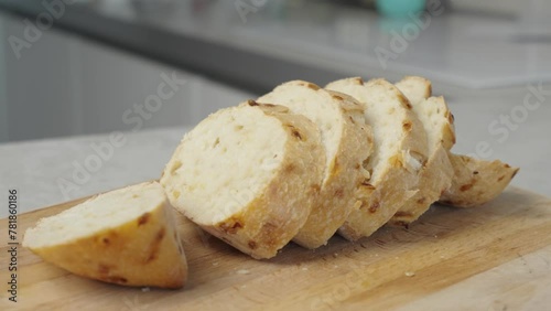 In the video, sliced white bread lies on the board, creating a cozy atmosphere for cooking classes, product advertisements, and culinary blogs
