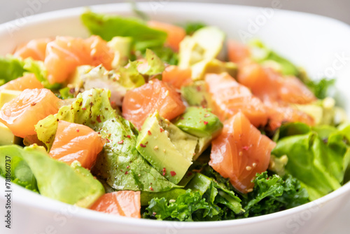 Green salad, avocado with toro salmon. Healthy and balanced menu.