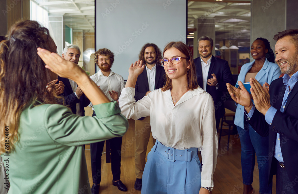 Happy female colleagues giving high five at meeting at the office, celebrating success, making a deal or business achievement. Coworkers applaud congratulating their partners on job well done. Happy female colleagues giving high five at meeting at the office, celebrating success, making a deal or business achievement. Coworkers applaud congratulating their partners on job well done.