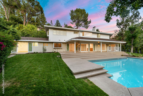Spacious backyard with pool and grassy area at renovated Los Angeles residence