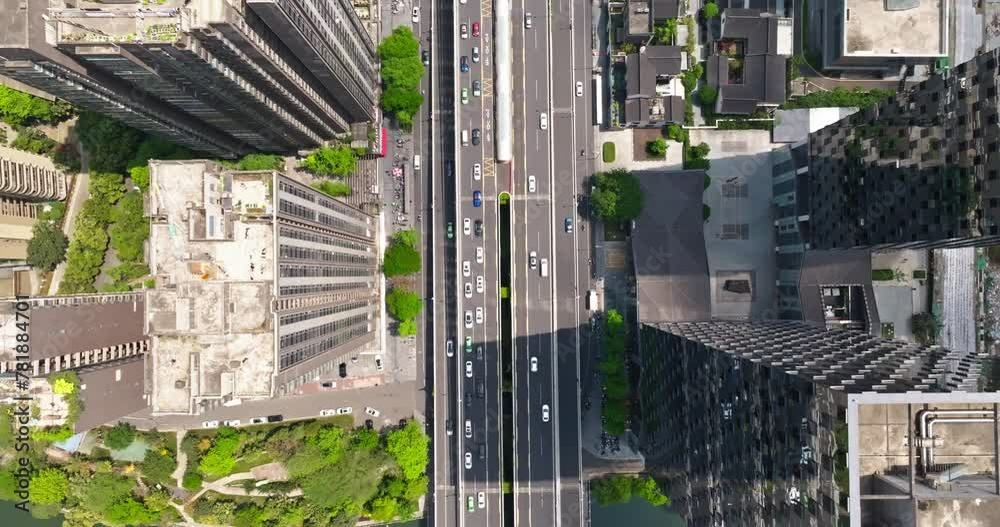 Aerial top view of Chengdu Cityscape in spring sunny day with cars driving on the road in the middle of high buildings Aerial top view of Chengdu Cityscape in spring sunny day with cars driving on the road in the middle of high buildings